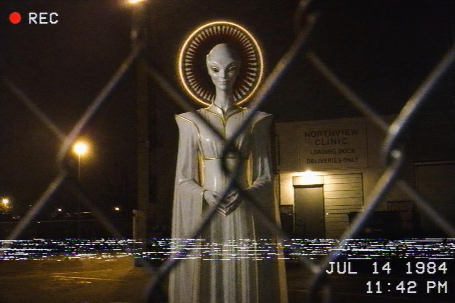 A VHS frame of a Guest whose halo has turned into a ring of teeth